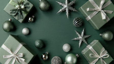 A festive frame combining sparkling silver snowflakes with soft green decorations.の写真素材