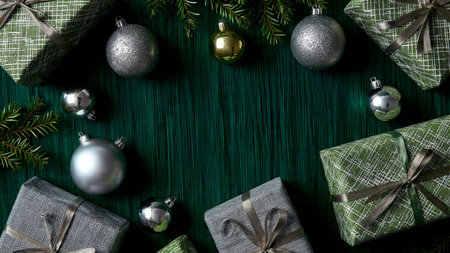 A festive border made of deep green baubles and shimmering metallic silver ribbons.の写真素材