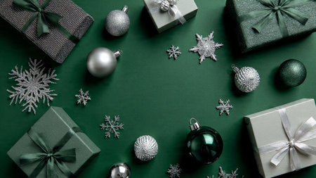 A chic festive layout mixing soft green hues with glittering silver snowflakes.の写真素材