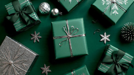 Christmas composition with pale green hues and metallic silver touches forming a polished border.の写真素材