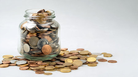 Clean professional savings visual showing a jar and a balanced cluster of coins, commercial-safe.