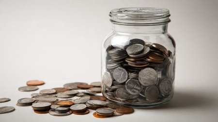 Modern minimalist setup with a tipped jar forming a soft trail of coins.