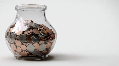 Modern wealth visualization showing a jar tipped over as coins spill gently across a smooth white...