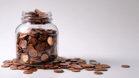 High-key studio theme showcasing polished coins arranged in rows beside a transparent jar.
