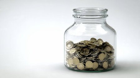 Soft elegance displayed through a jar with a few coins scattered gently around it.