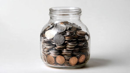 Clean wealth imagery featuring a tipped jar and coins flowing smoothly across a surface.
