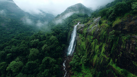 A calm river with soft currents winding through a quiet countryside landscape.の写真素材