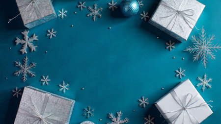 Icy-toned holiday layout with soft blue gift boxes and reflective silver snowflakes.の写真素材
