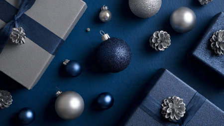 Clean winter commercial layout featuring a deep-blue matte panel with neatly arranged silver elements.の写真素材