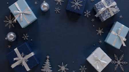 Luxury holiday layout with matte blue textures and high-end silver baubles arranged in a precise pattern.の写真素材