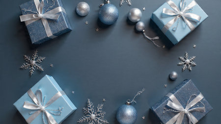 Rustic winter flat lay with aged silver ornaments resting on a textured navy background.の写真素材