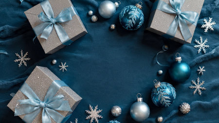 Modern festive top view featuring deep-blue matte textures and sparkling silver details.の写真素材