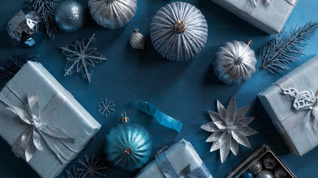 Chrome-finish gift ribbon placed over a monochrome navy wrapping scene.の写真素材