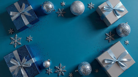 Rustic winter flat lay with aged silver ornaments resting on a textured navy background.の写真素材