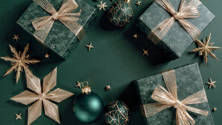 Premium winter layout with champagne-gold ornaments placed gracefully on a rich emerald background.の写真素材