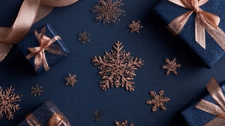 A premium holiday gift arrangement combining matte blue textures and metallic ribbons.の写真素材