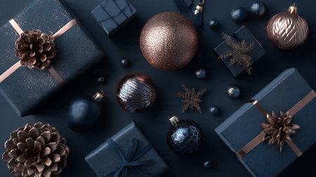 A delicate arrangement of rose-gold snowflakes placed on deep textured blue.の写真素材