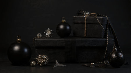 Elegant gold ribbon loops arranged over a sleek black base.の写真素材