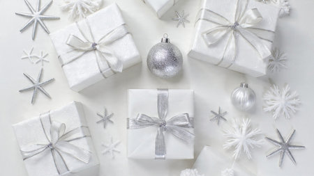 Christmas background. White gift boxes with silver ribbons and snowflakes on white background.