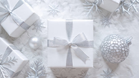 Christmas and New Year background. White gift boxes with silver ribbon and snowflakes.