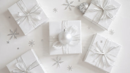 Christmas and New Year background. White gift boxes with ribbons, snowflakes on white background....