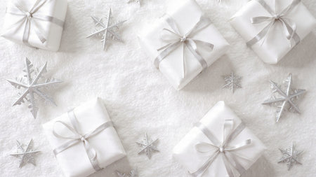 Christmas and New Year background. White gift boxes with silver snowflakes. Flat lay, top view.