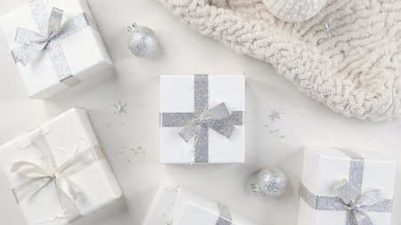 Christmas composition. White gift boxes with silver ribbon on white background. Flat lay, top view, copy spaceの写真素材