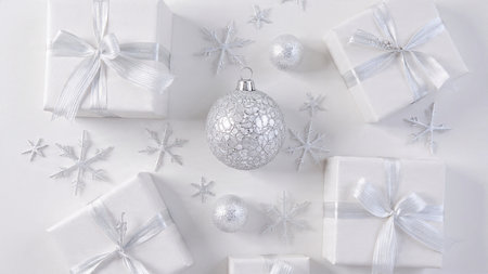 Christmas background with gift boxes, silver ball and snowflakes on white backgroundの写真素材