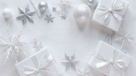 Christmas background. White gift boxes, silver decorations and snowflakes on white background. Flat lay, top view, copy spaceの写真素材