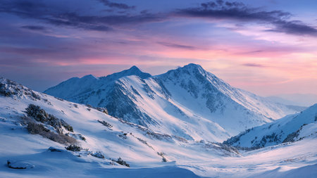 Morning pastels illuminate the intricate snowy surfaces.