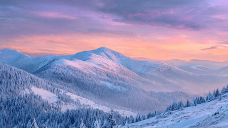A glowing pastel horizon brings life to the snow-covered mountains in this premium winter capture.