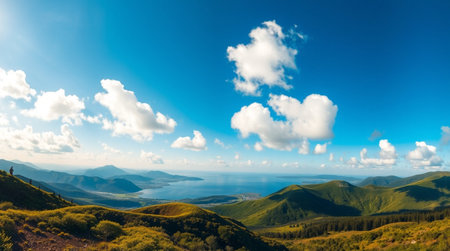 Green alpine valley surrounded by high peaks and clear skies.の写真素材
