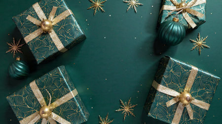 Christmas and New Year background with green gift boxes and decorations. Top view.