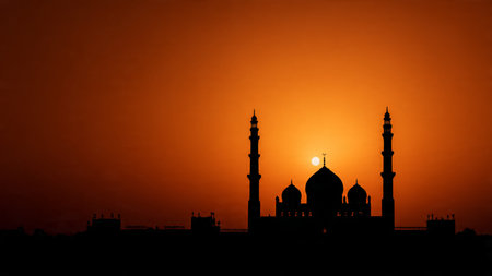 Silhouette of mosque at sunset. Ramadan Kareem background.