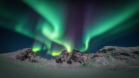Aurora borealis, northern lights over snowy mountains, Iceland