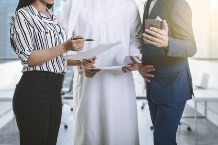 Meeting between Arab man and tow European business and communicationの写真素材
