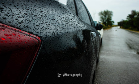 Closeup of raindrops on the rear side of a car.の写真素材