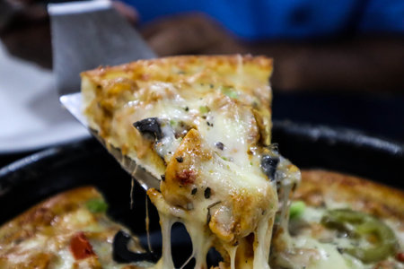 Pizza on the black plate, close-up, selective focus