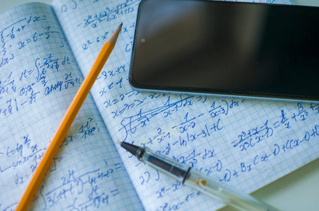 Mathematics Notebook with Calculus Equations and Smartphone