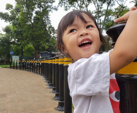 Asian girls smile when they play on the playgroundの写真素材