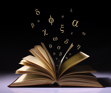 opened old book with flying greek letters on black and white background