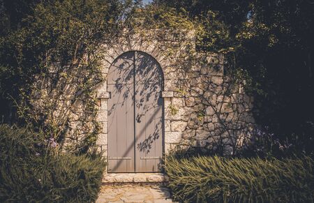 old stone wall and wooden gateの写真素材