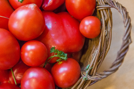a basket filled of vibrant red tomatoesの写真素材