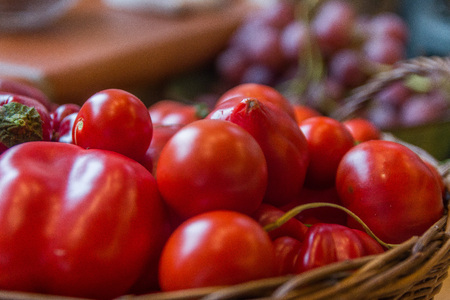 a basket filled of vibrant red tomatoesの写真素材