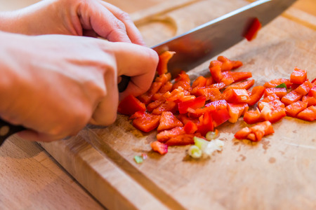 woman cutting vegetables for dish closeupの写真素材