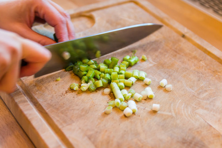 woman cutting vegetables for dish closeupの写真素材