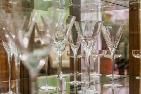 beautiful cone glasses resting on a glass shelfの写真素材