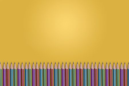 Green purple red and cyan sharp striped pencils align on yellow radial gradient backgroundの写真素材