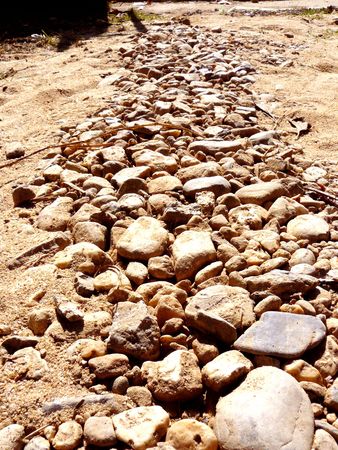 The rock trail or gravel stone way on the ground sand go straight to the big gate.の写真素材