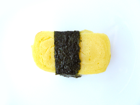 Japanese food. Close up top view of sushi sweet egg roll with seaweed on isolated on white background.の写真素材